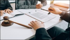 Multiple people at a table signing documents