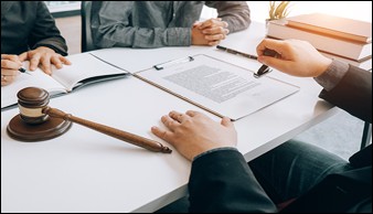 Multiple people at a table signing documents
